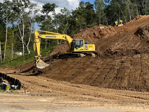 Excavator on side of hill